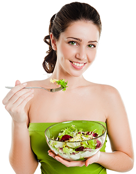 A woman eating a bowl of salad