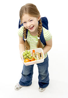 A photo of a girl with a lunchbox