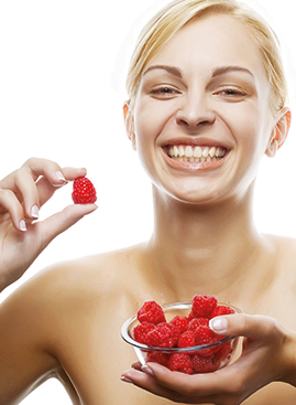 A photo of a woman with a bowl of antioxidant-rich berries